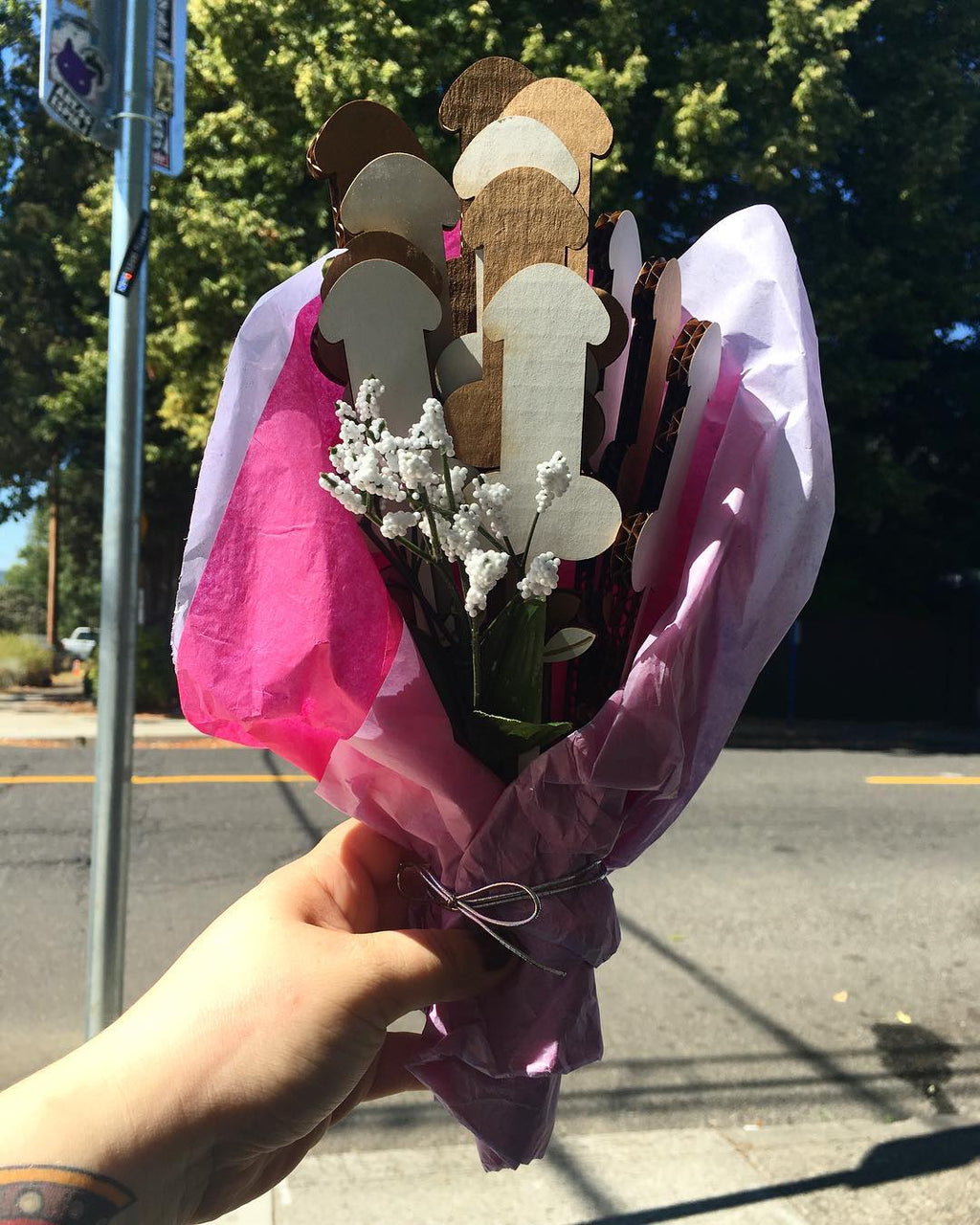 Photo of a dick bouquet in a girl's hand on the street